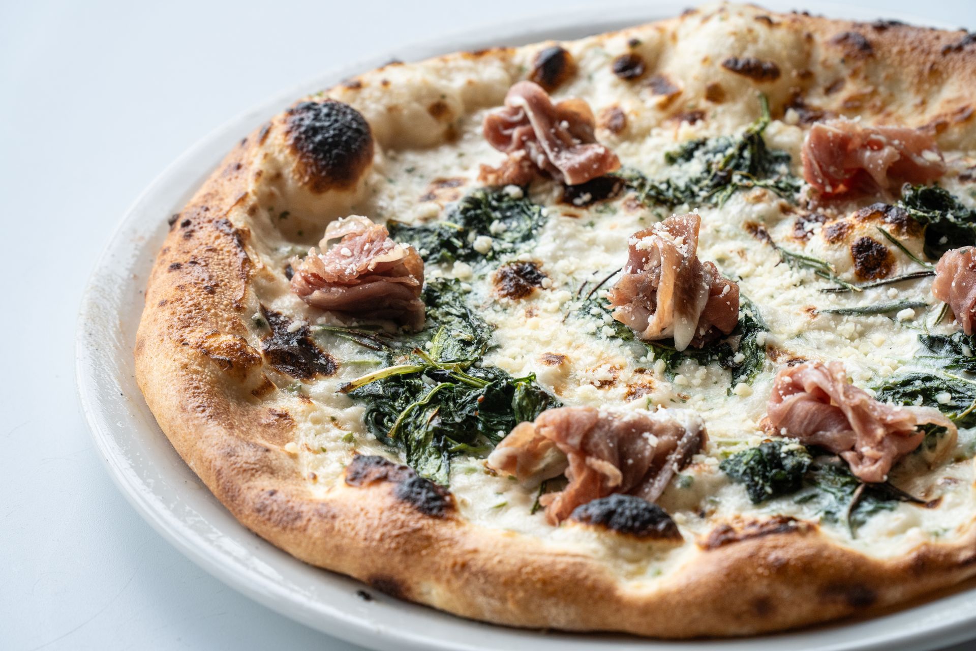 A hotel room with two beds , a couch , a desk and a television.