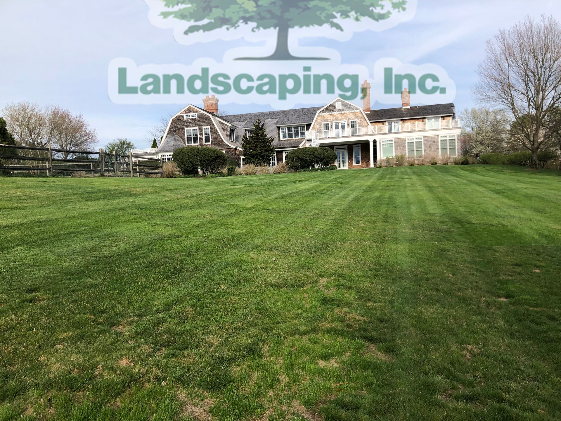 Well-manicured lawn in front of a large house with a 