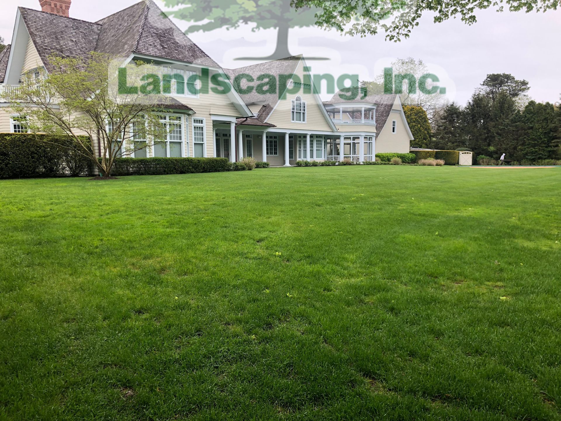 Large house with manicured lawn; 
