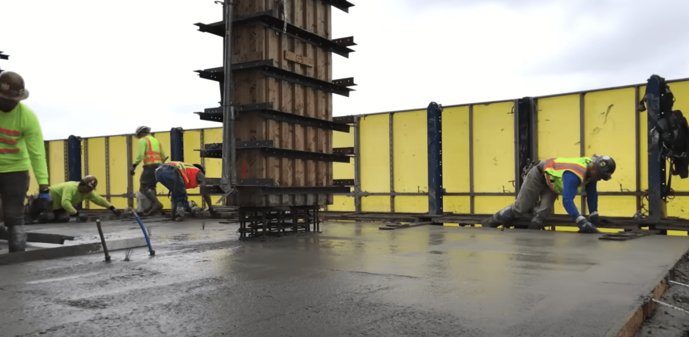 Commercial Concrete company works on pouring concrete for a highrise building