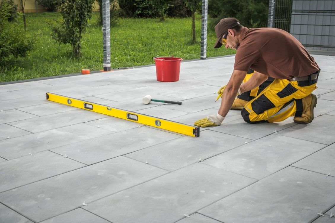 Concrete patio contractor laying out the specs of a project in Blaine, MN
