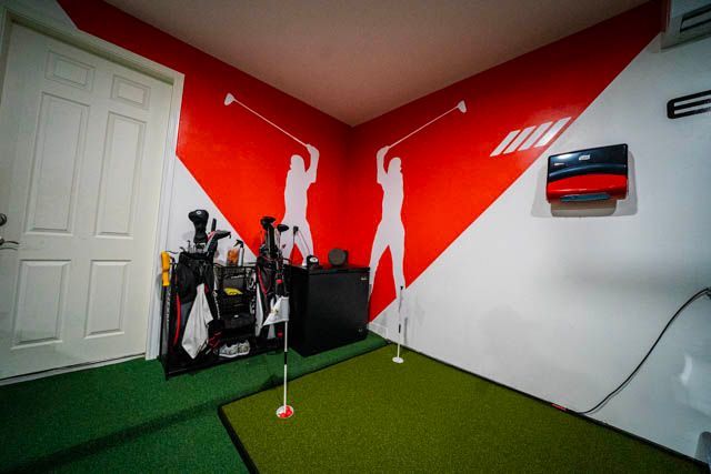 A Man Is Kneeling On The Floor Working On An Electrical Outlet
