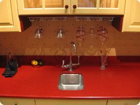 A kitchen with red counter tops and a sink