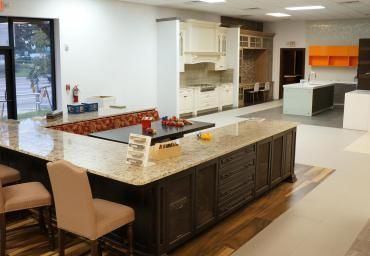 A kitchen with a large island in the middle of the room.