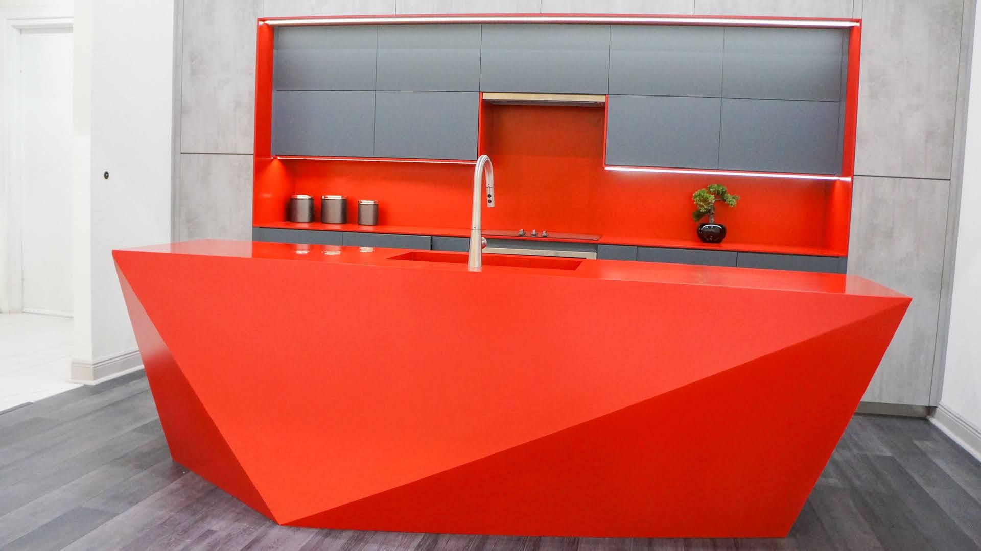 A kitchen with red counter tops and a sink