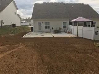 The backyard of a house with a patio and a gazebo.