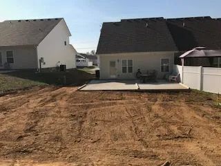 There is a lot of dirt in the backyard of a house.