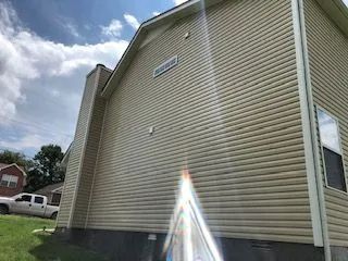 A large house with a white truck parked in front of it.
