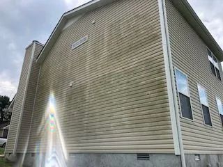 The side of a house with a lot of stains on it.