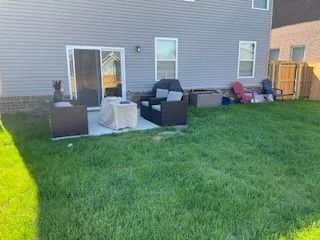 There is a patio area in the backyard of a house.