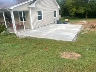 A house with a concrete patio in front of it.