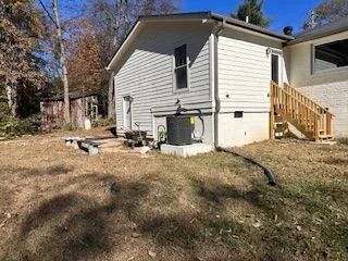 The backyard of a house with a picnic table and stairs.