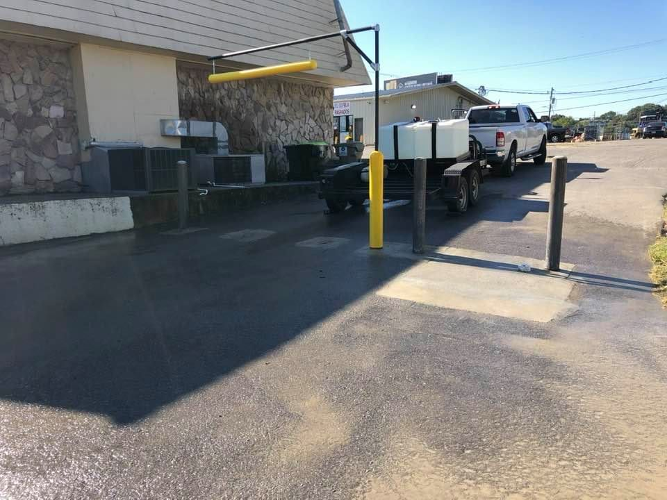 A parking lot with cars parked in front of a building.