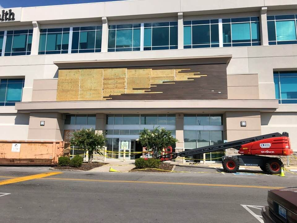 A large building with a lot of windows is being remodeled.