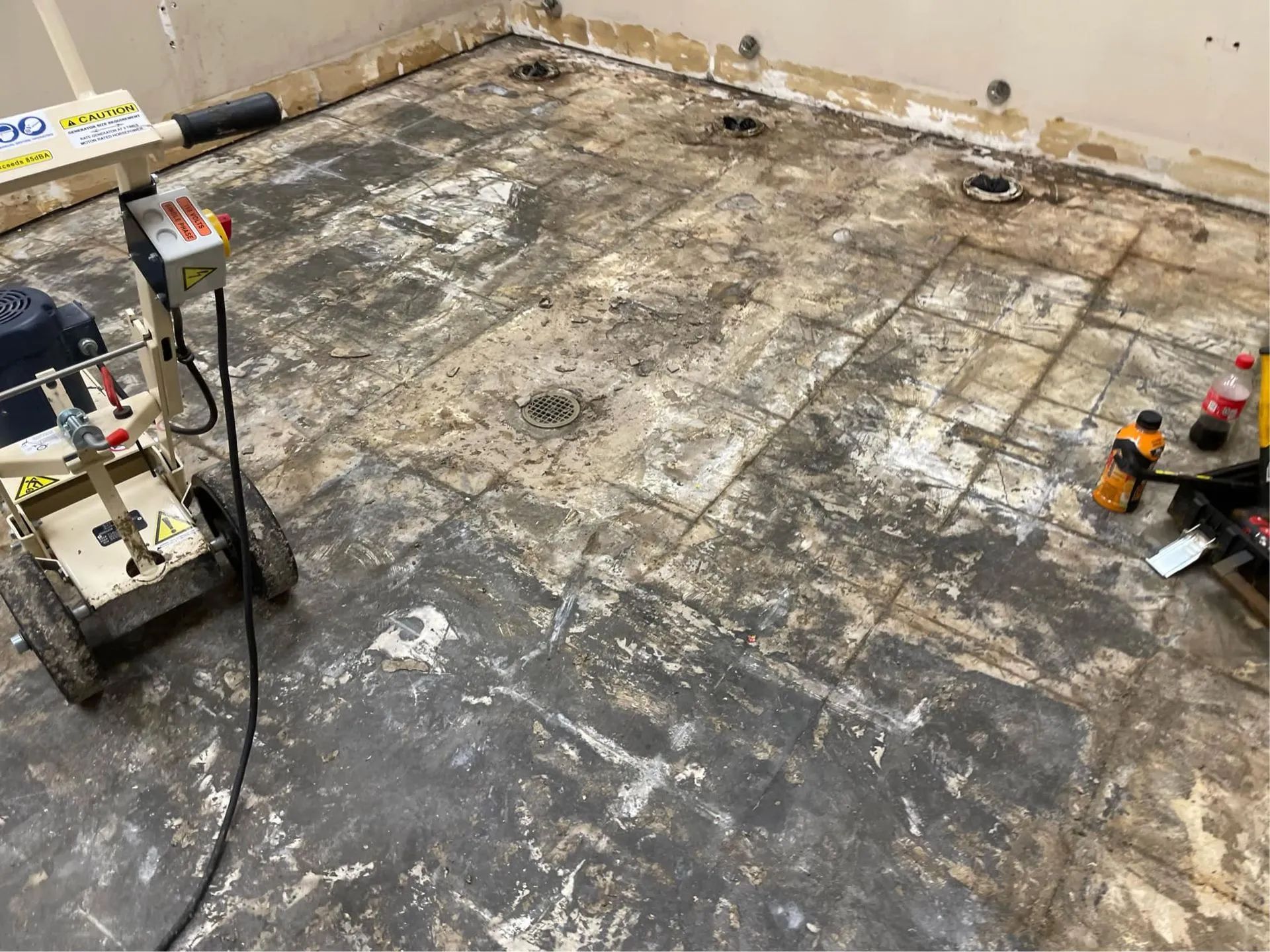 A machine is sitting on a tiled floor in a room.