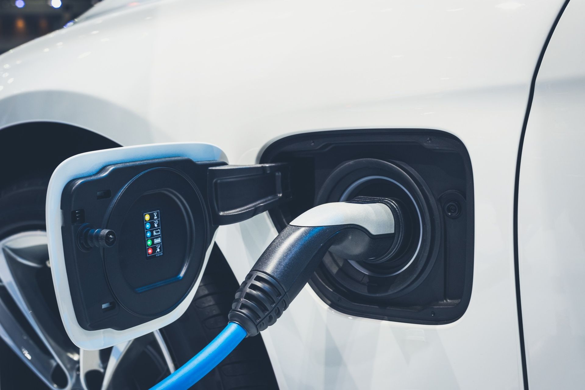 A close up of an electric car being charged.