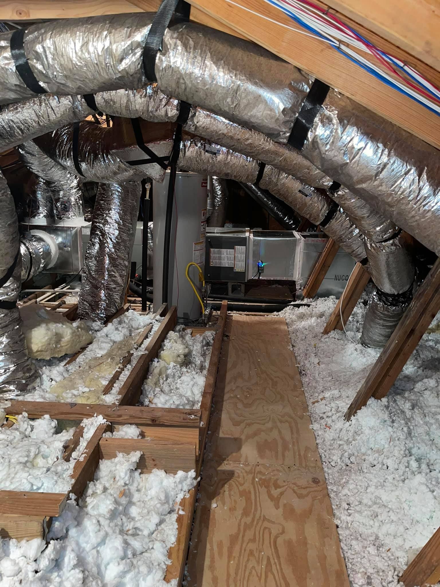 There is a lot of insulation in the attic of a house.