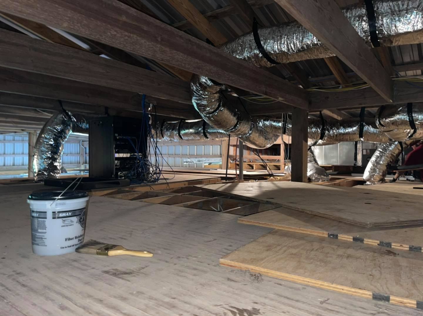 There is a bucket of paint and a brush in the attic.