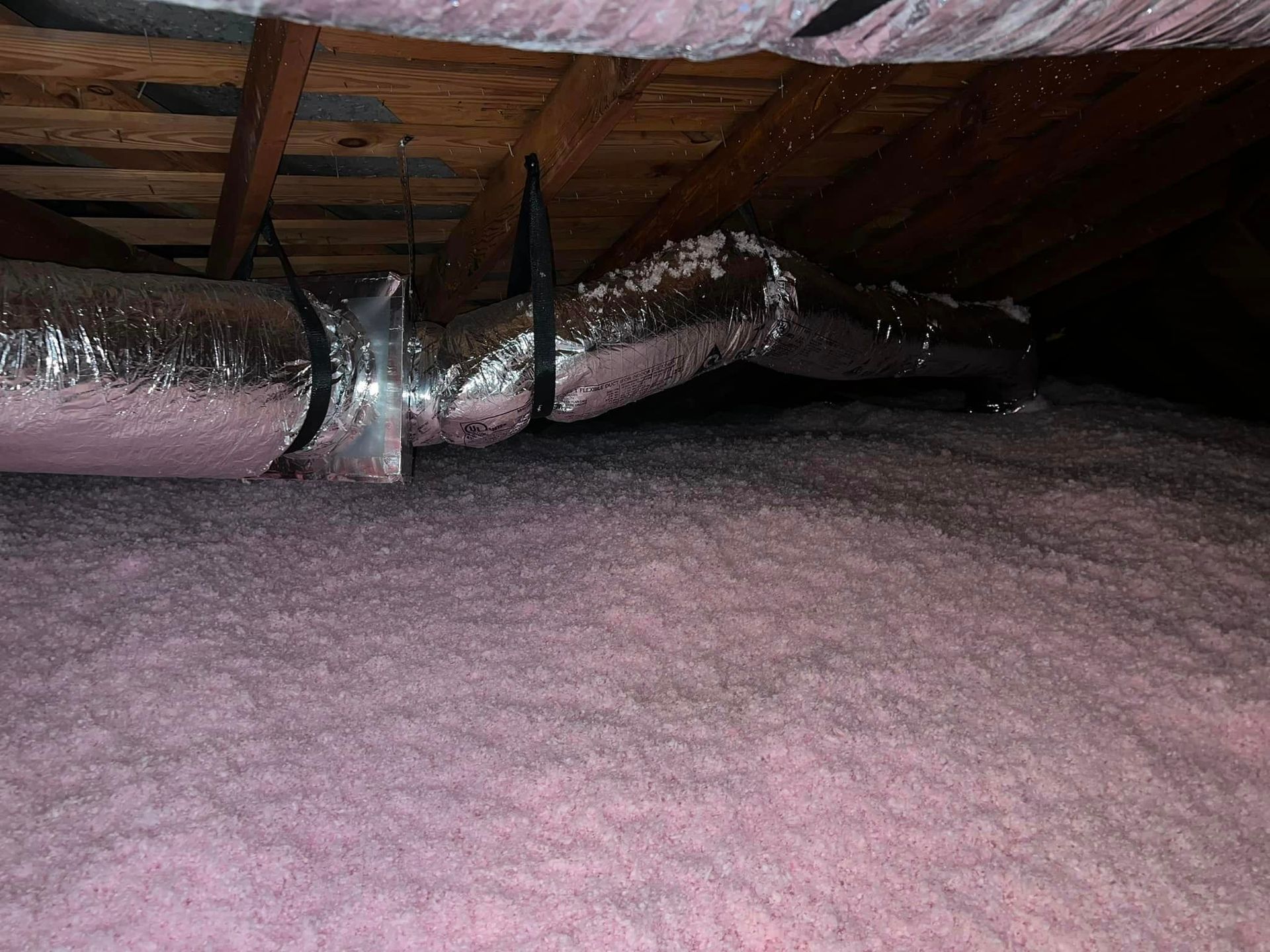 There is a lot of pink insulation in the attic. 