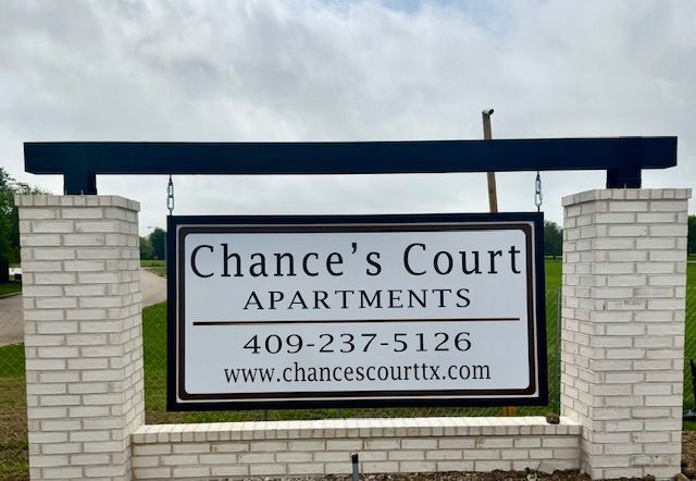 A sign that says chance 's court apartments on it
