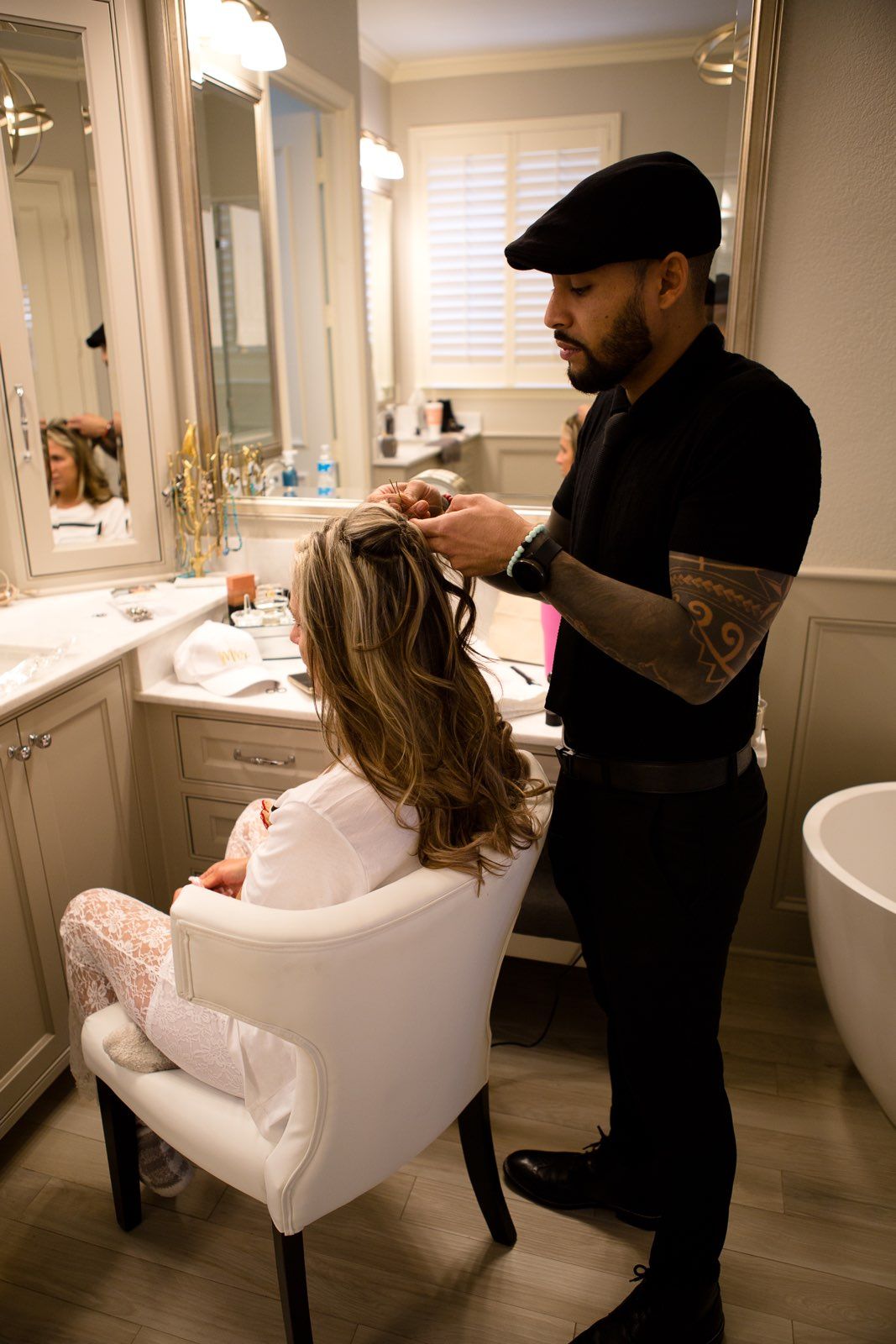 A man is getting a woman 's hair done in a bathroom.