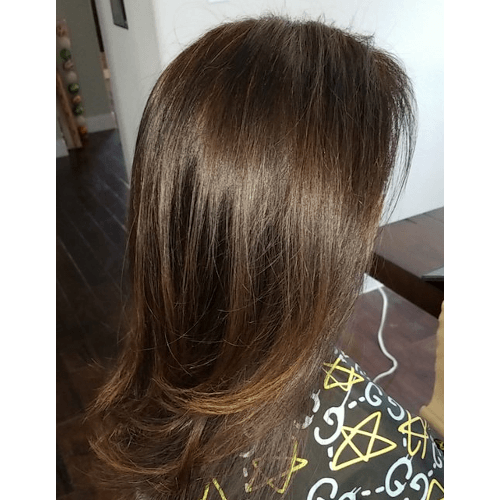 A close up of a woman 's hair sitting on a table.