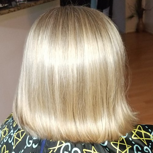The back of a woman 's blonde hair is shown.