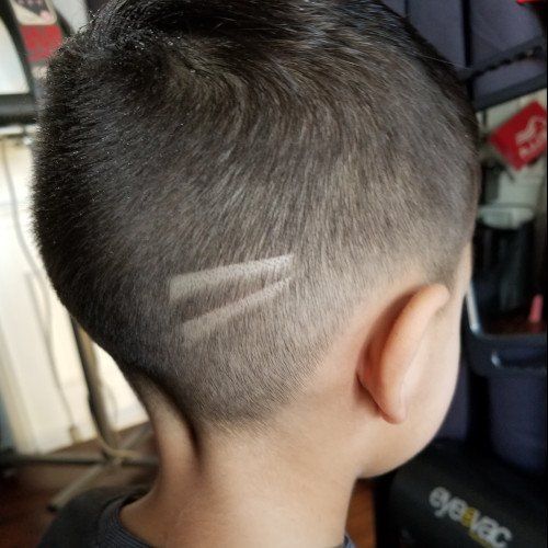 A young boy with a shaved design in his hair