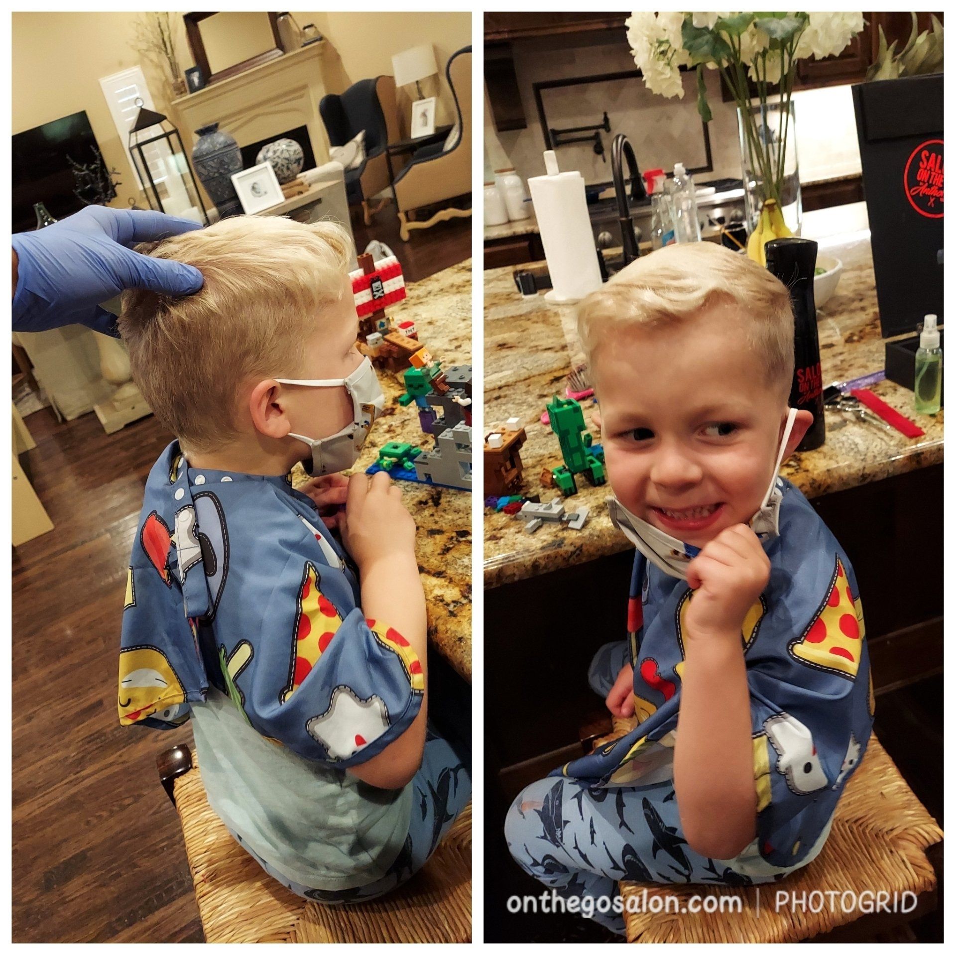 A little boy is getting his hair cut at a barber shop