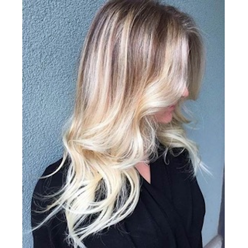 A woman with long blonde hair is wearing a black shirt.