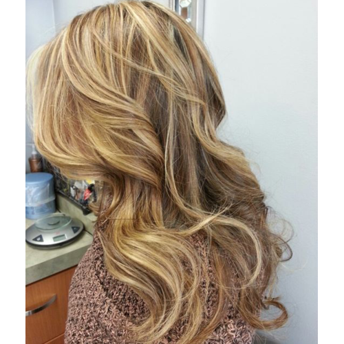 A woman with long blonde hair is wearing a brown sweater.