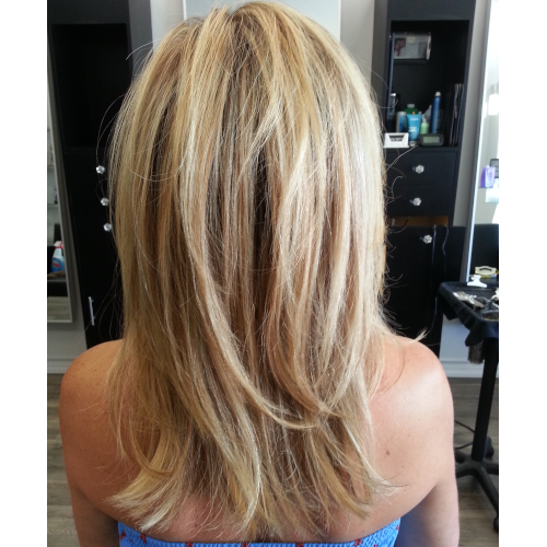 The back of a woman 's blonde hair is shown