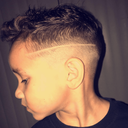 A young boy with a shaved line in his hair