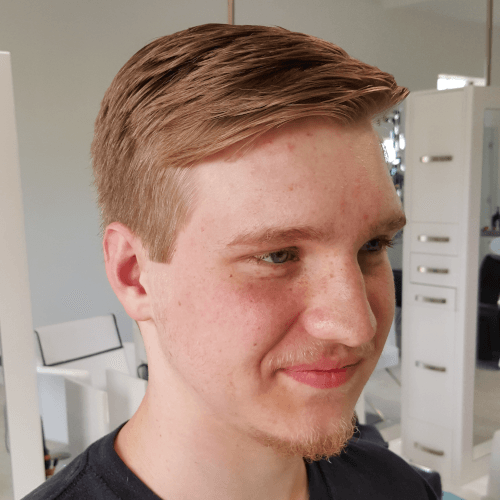 A young man with a beard wearing a black shirt