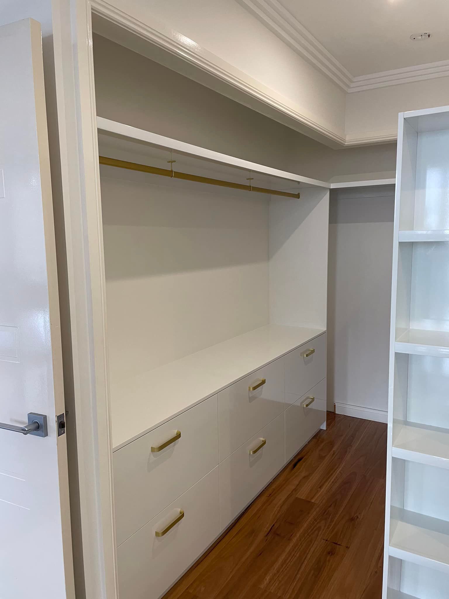 A Walk in Closet With Lots of Drawers and Shelves — Cairns Custom Wardrobes in Manunda, QLD