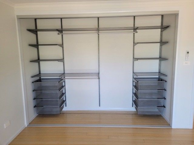 A Closet With Shelves and Drawers in It — Cairns Custom Wardrobes in Manunda, QLD