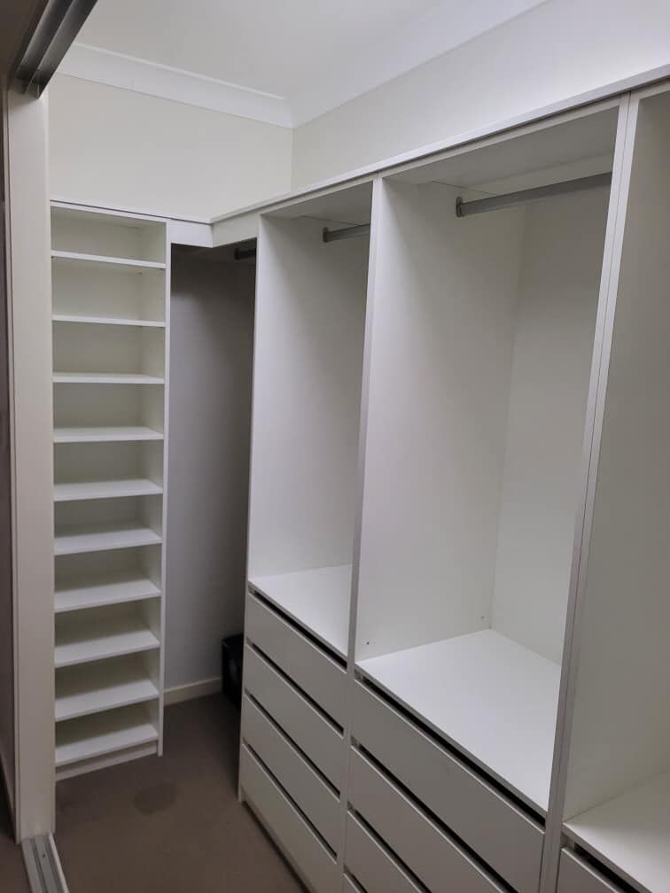 A Walk in Closet With Lots of Shelves and Drawers — Cairns Custom Wardrobes in Manunda, QLD