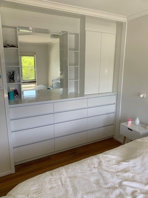 A Bedroom With a Bed, Dresser, and Mirror — Cairns Custom Wardrobes in Manunda, QLD