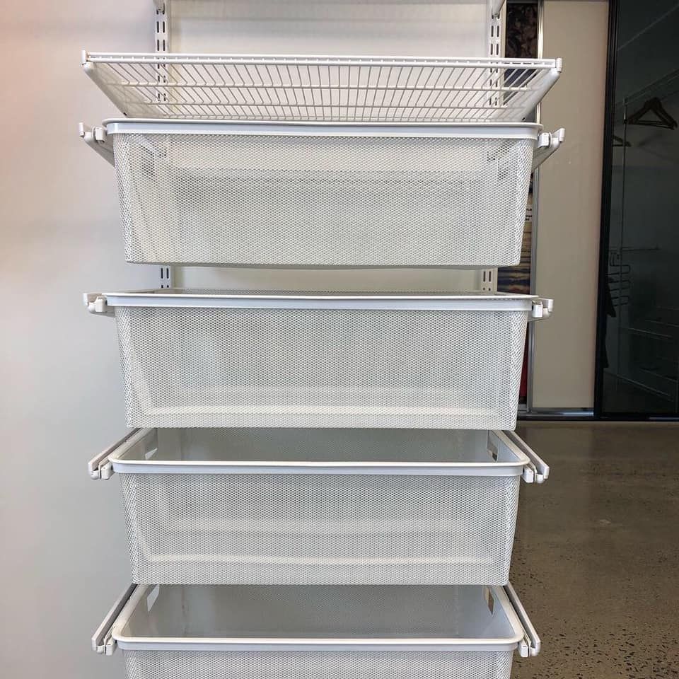A Row of White Baskets Stacked on Top of Each Other on a Wall — Cairns Custom Wardrobes in Manunda, QLD