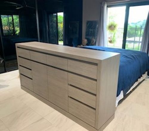 A Bedroom With a Bed, Dresser, and Sliding Glass Doors — Cairns Custom Wardrobes in Manunda, QLD