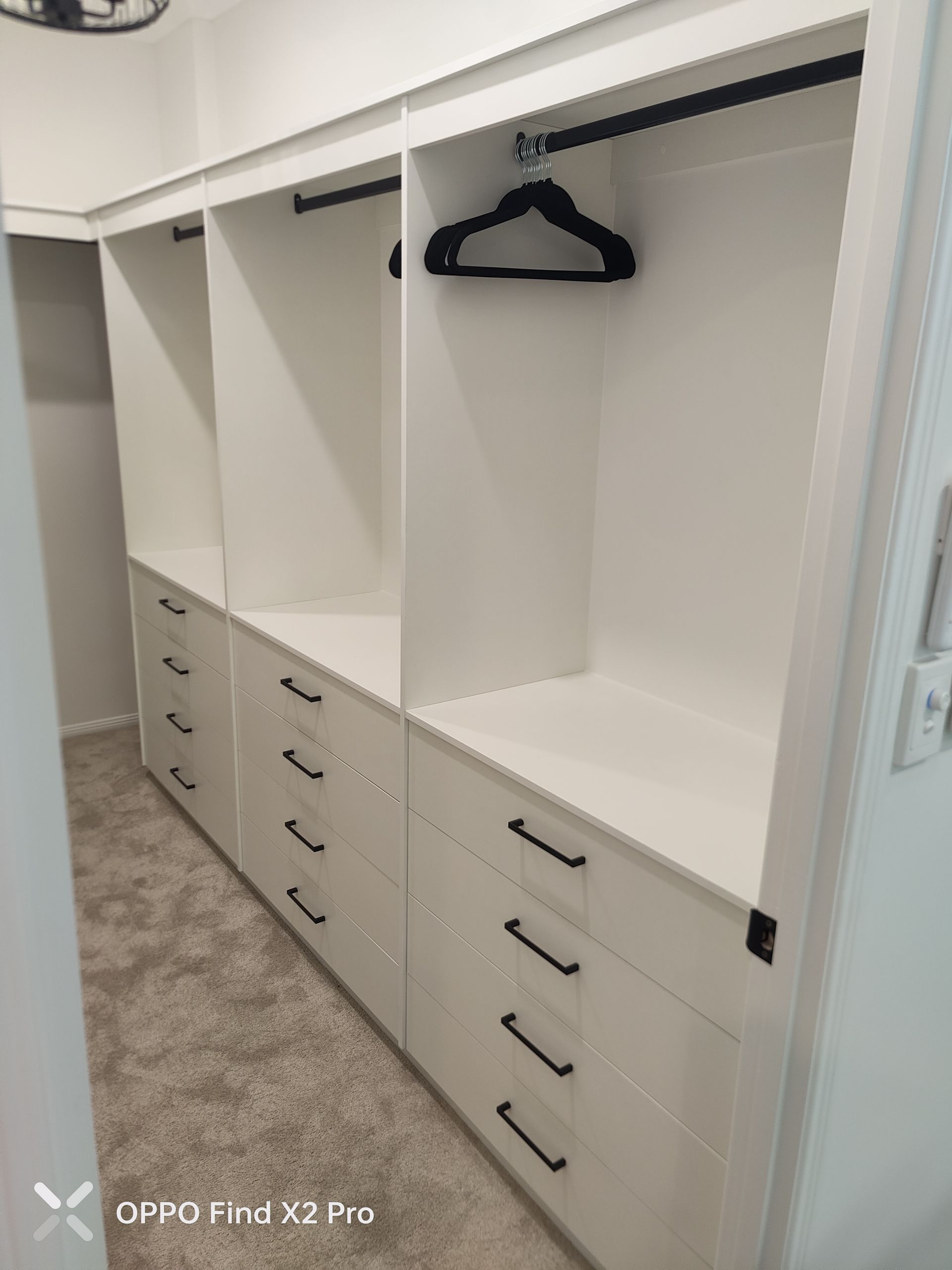 A wardrobe with white draws and black hangers — Cairns Custom Wardrobes in Manunda, QLD