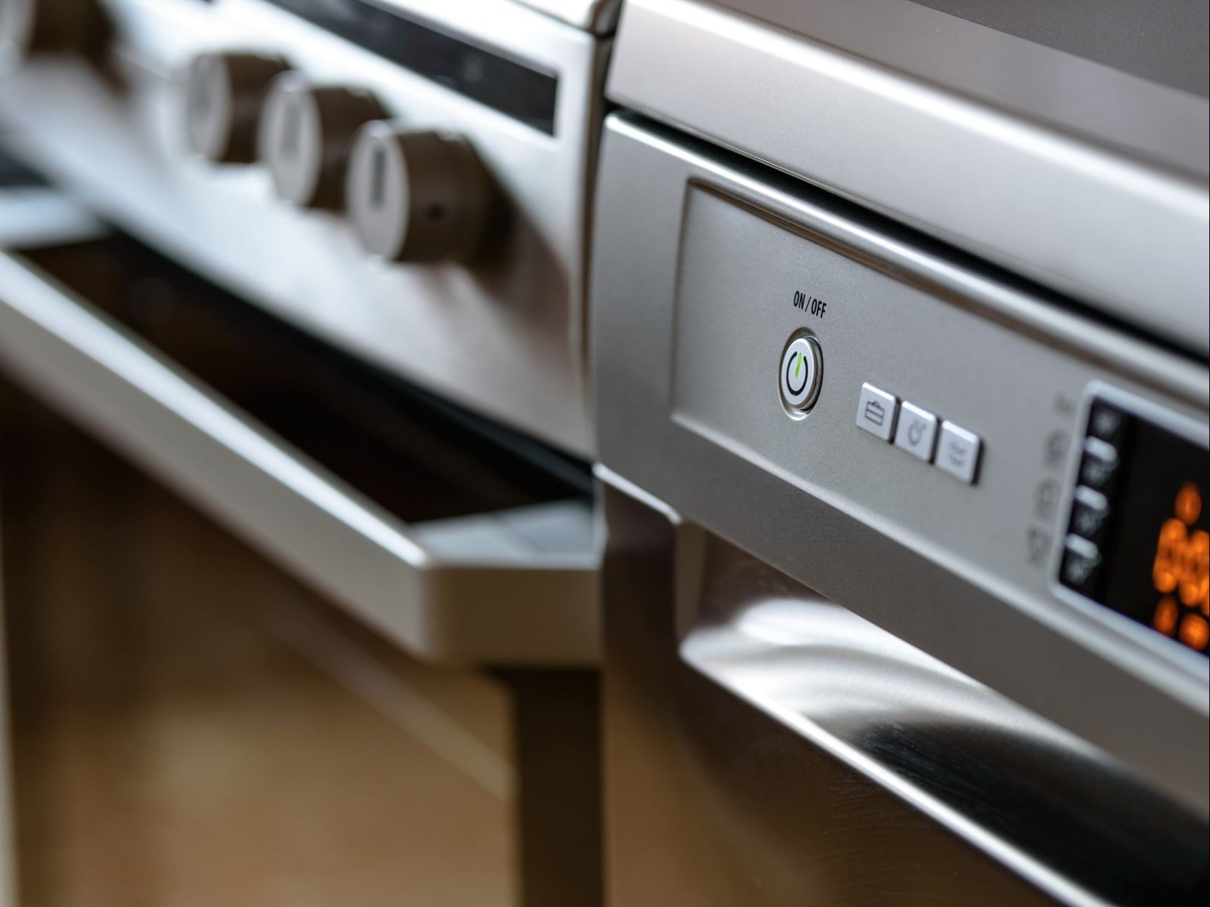 A close up of a stove and dishwasher in a kitchen.