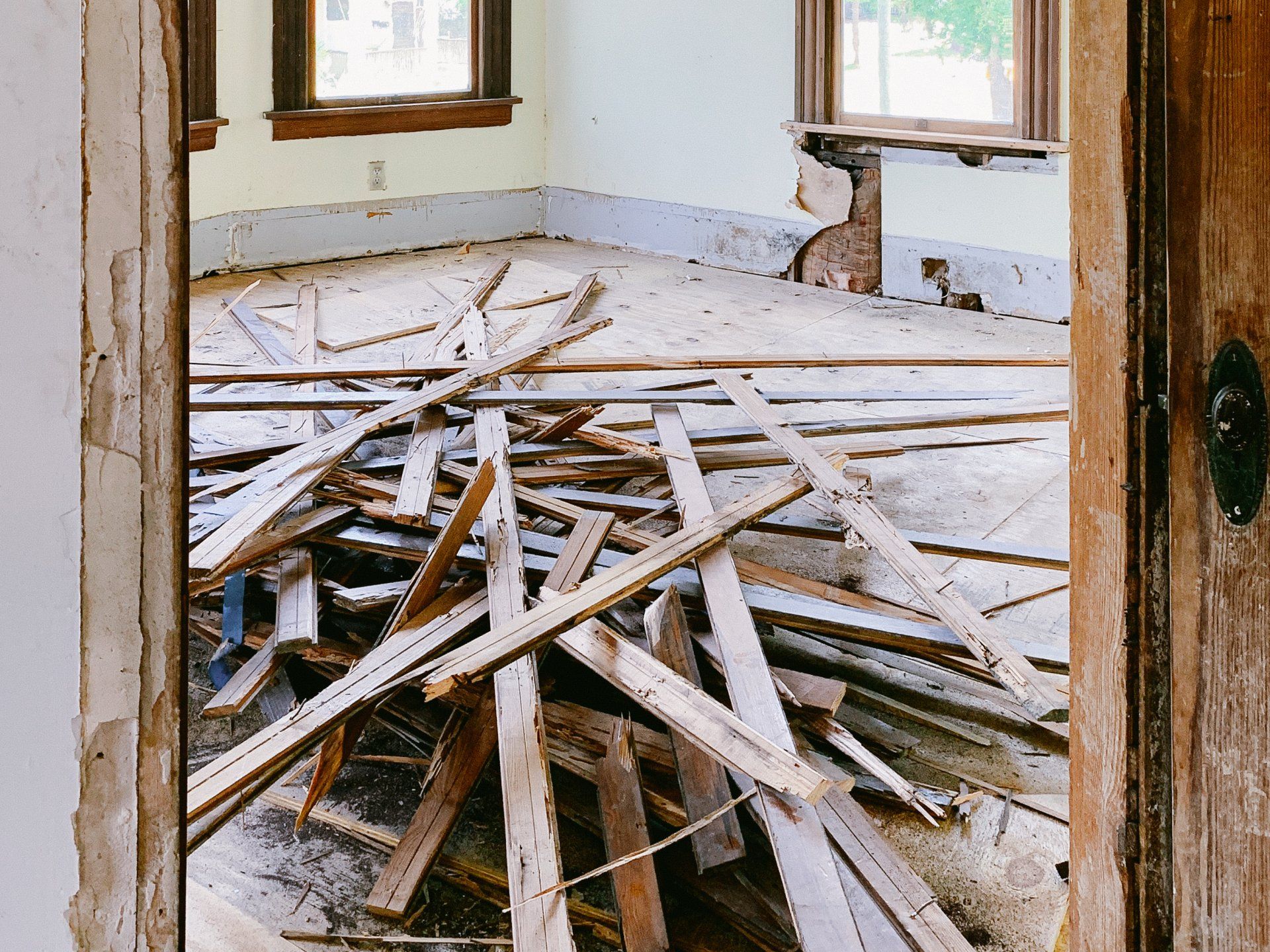 A room with a lot of wood laying on the floor