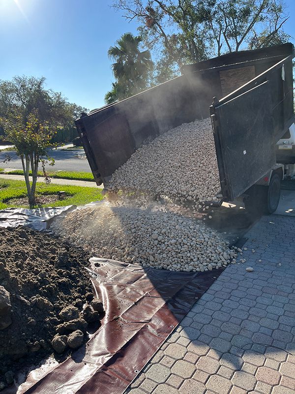 bulk rock delivery on tarps in driveway