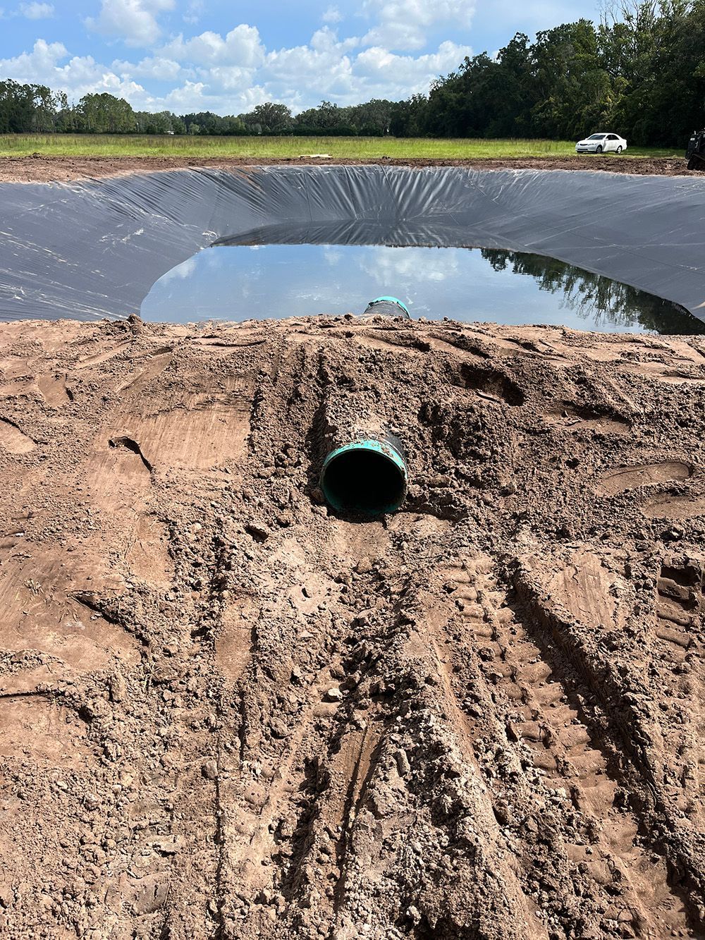 overflow pipe buried in pond berm