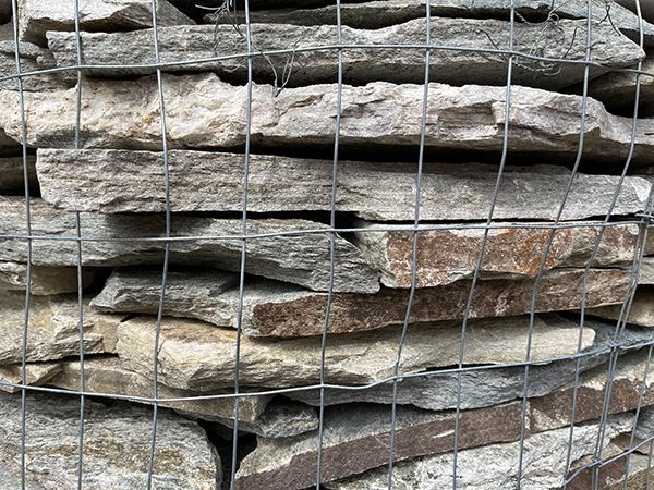 flagstone stacked in the parking lot of Tampa Bay Ponds