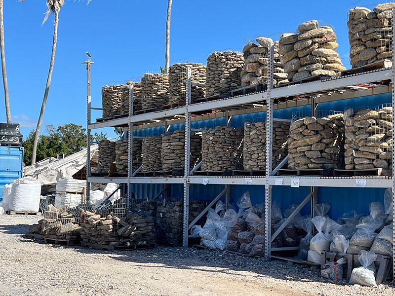 3 shelves of stone stacked outdoors in Dunedin