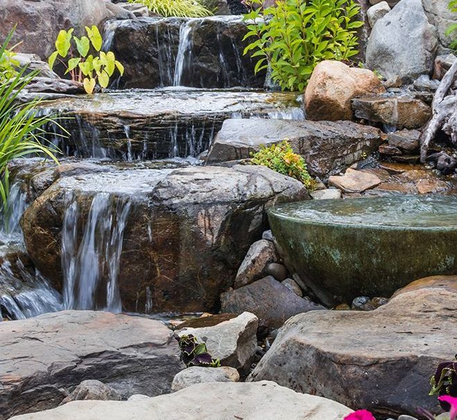 bowls and rocks spilling water into each other