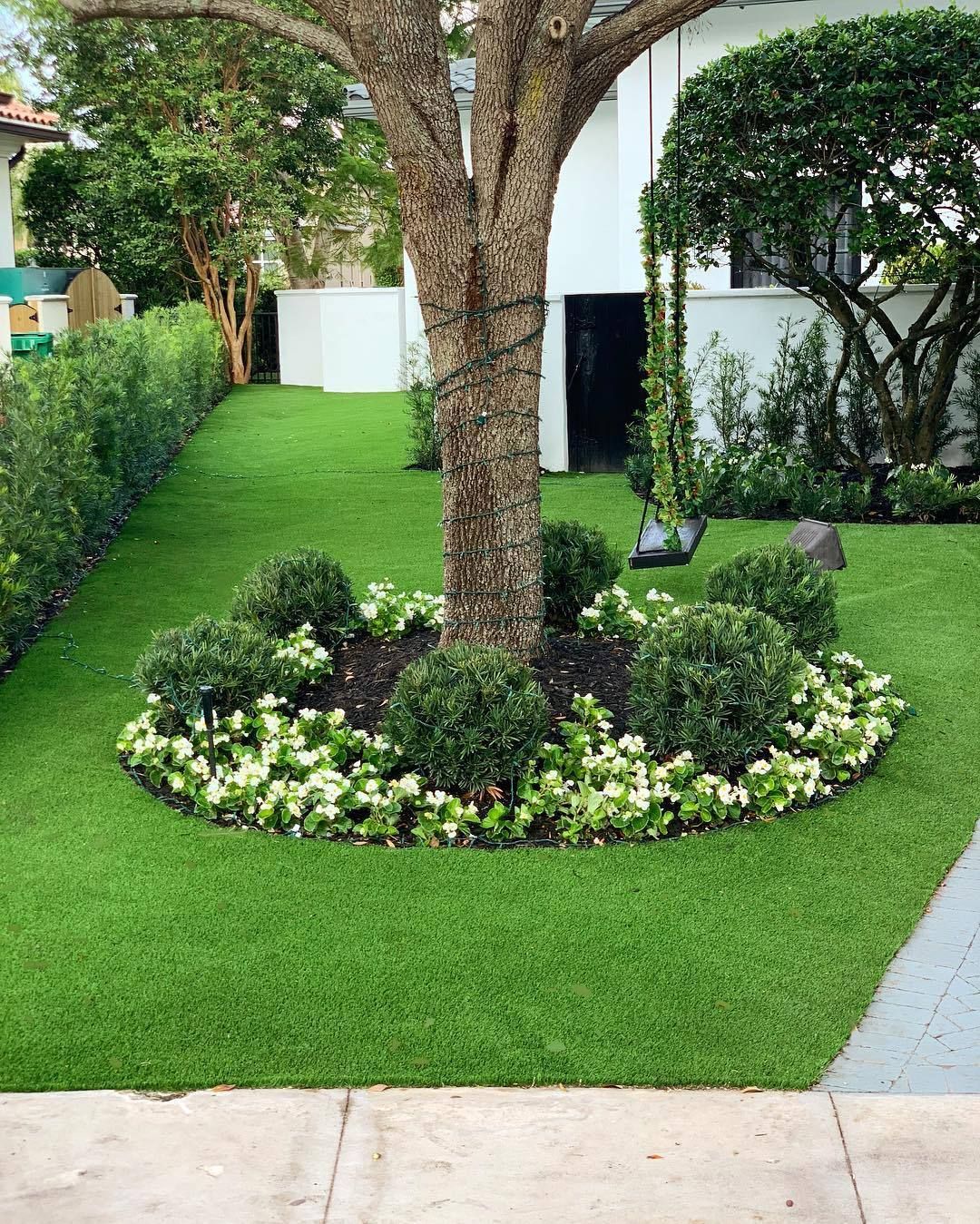 beautiful landscaping with tree and garden bed after landscaping