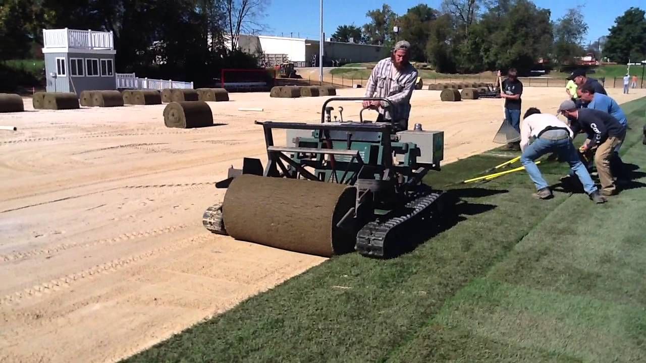 man using sod laying machine